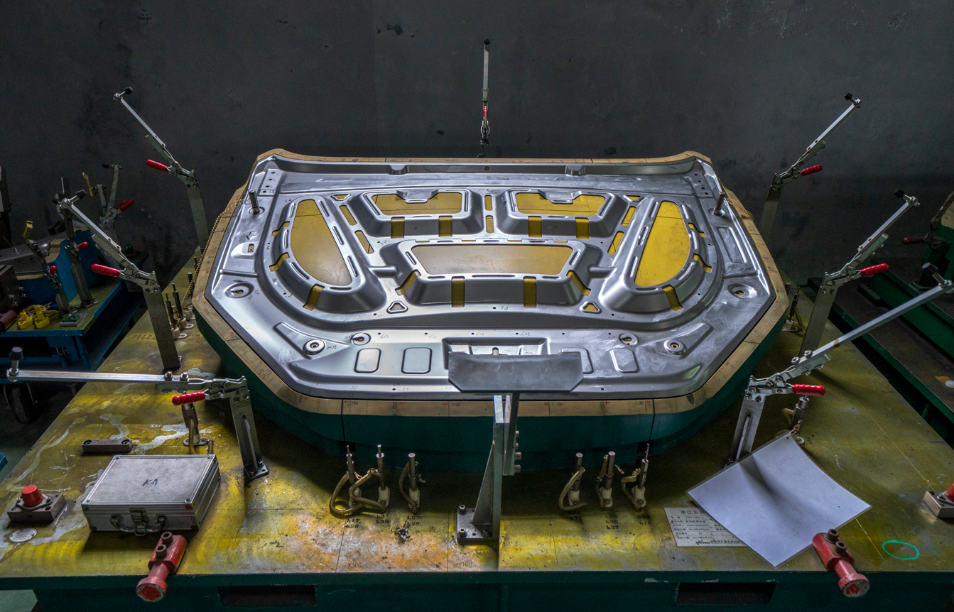 Automotive sunroof guide rails and structural frames — progressive die stamped